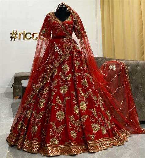 Flared red lehenga with a heavy embroidered veil – Ricco India