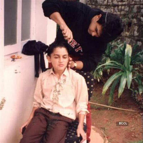 A candid picture of Aamir Khan helping a young Imran Khan getting ready