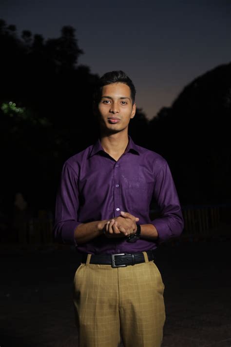 Man in Brown Long Sleeves Sitting on a Wall · Free Stock Photo