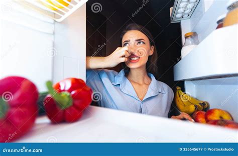 Woman Closing Nose Near Refrigerator, Feeling Bad Smell Stock Image ...