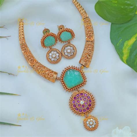 Antique Gold Hasli Necklace Set with Green Floral Motif – Sparkle and Glow