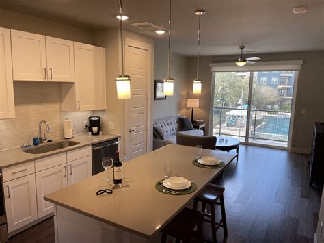 Kitchen and Patio within Corporate Apartments in Stone Oak, San Antonio, TX-min | Alamo ...