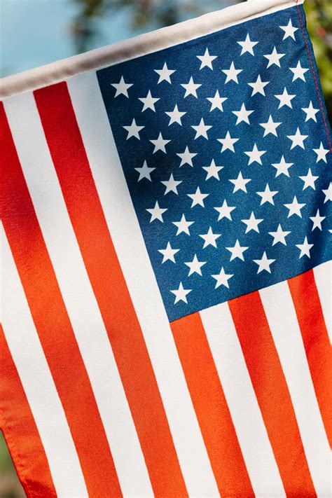 Colorful American flag with stripes representing equity and endurance · Free Stock Photo
