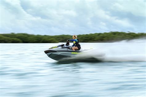 A woman performing a stunt on her Sea-Doo Spark with the words “Make Waves sales event”