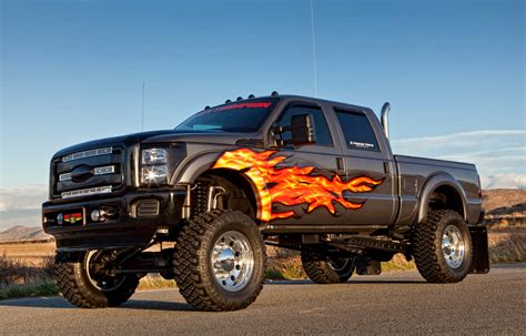 Download A Black Truck With Flames On It Wallpaper | Wallpapers.com