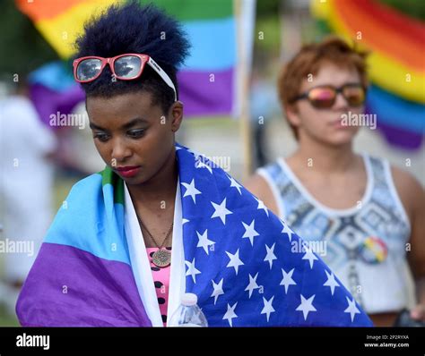 Khadijah Johnson, of Albertville, is draped in an American rainbow flag ...