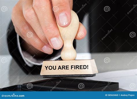 Hand Holding Rubber Stamp With You Are Fired Sign Stock Photo - Image ...