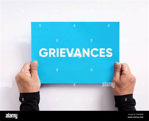Employee or customer grievance. Grievance procedure business concept. Male hand holding a blue ...
