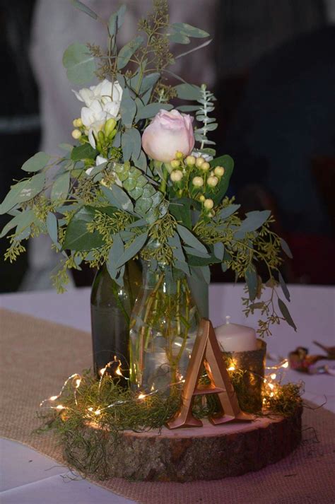 Rustic Wood Slice Centerpiece with Eucalyptus and Roses