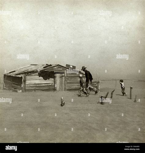 Farmer and sons walking in the face of a dust storm. Cimarron County ...
