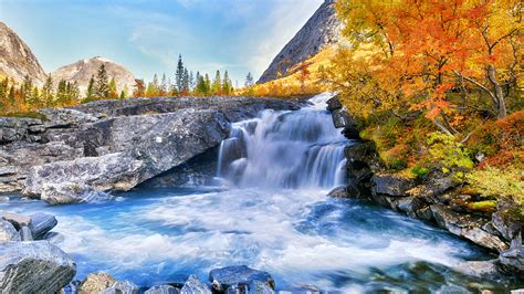 Beautiful autumn mountain landscape with yellow trees and waterfall ...