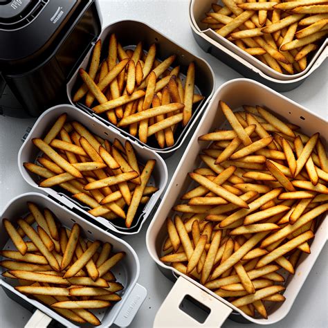 Crispy Golden French Fries with Fresh Green Onions in Air Fryer Basket.
