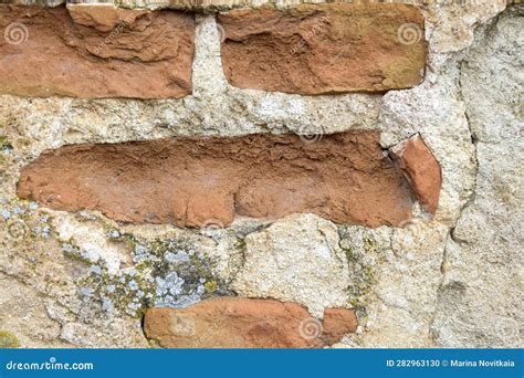 Old Worn Down Brick Wall with Plaster and Moss. Grunge Red Stonewall ...
