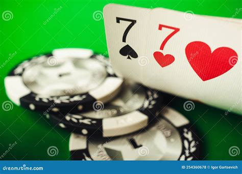 A Pair of Sevens and Poker Chips on a Green Background, Poker ...