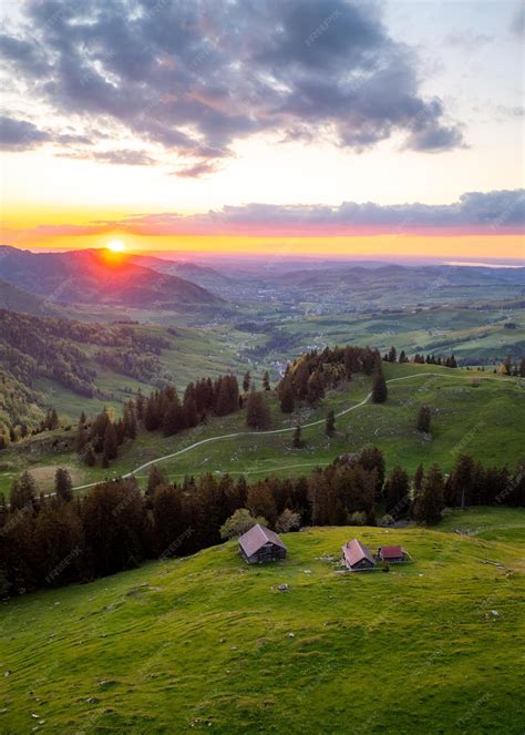 Premium Photo | A farm high on the hills during a sunset in the distance you can see a hilly ...