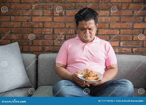 Young fat man eating stock photo. Image of home, fried - 111118750