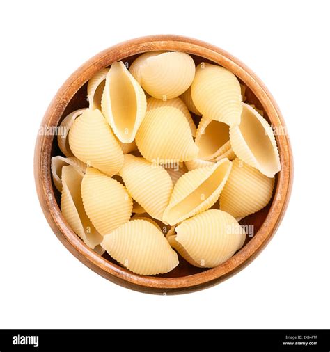Conchiglie rigate, shell shaped and furrowed Italian pasta in a wooden ...