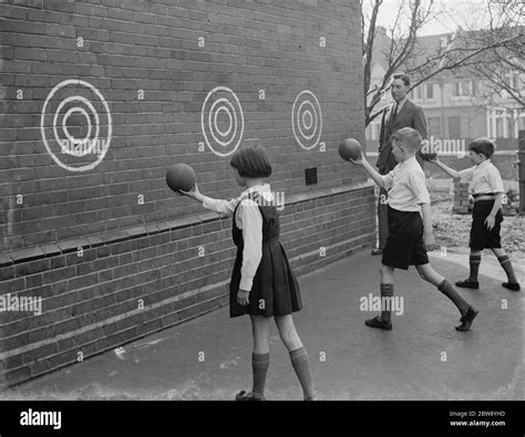 School children playing in playground Black and White Stock Photos ...