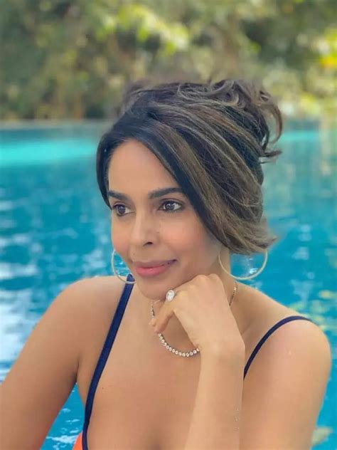 Mallika Sherawat goes Besharam Rang in orange bikini, jumps into pool ...