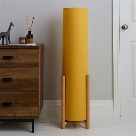 Finished in vibrant ochre this contemporary style Elements floor lamp ...