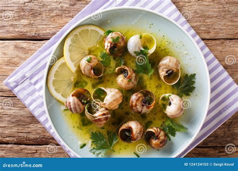 Raw Edible Sea Snails, Whelks Close-up And Lemon, Parsley, Garlic On A ...