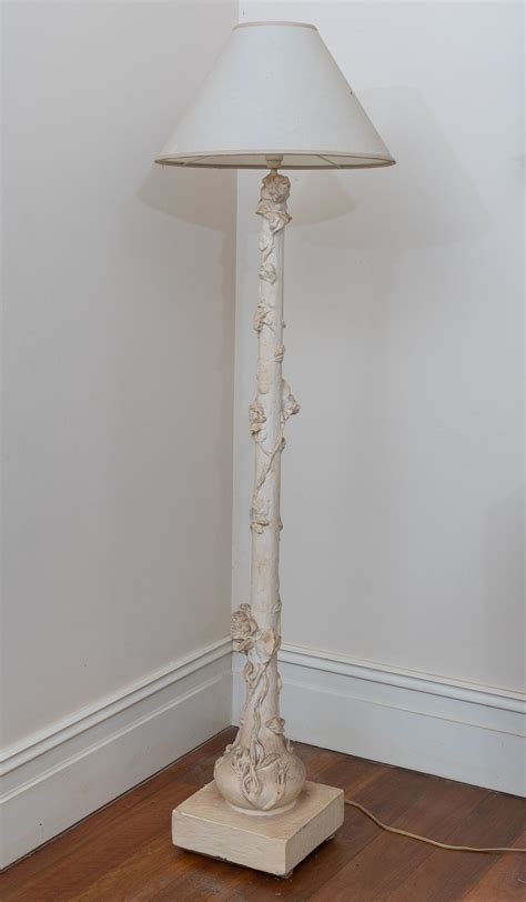Lot - A heavy cream floor lamp with cast vine design total height 165cm