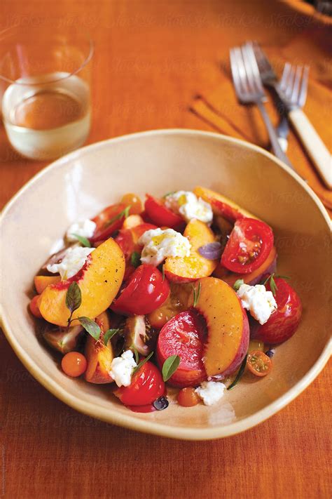 "Peach And Tomato Summer Salad" by Stocksy Contributor "Sara Remington" - Stocksy