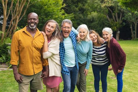 Portrait of happy multiracial senior male and female friends enjoying ...