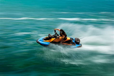 A woman performing a stunt on her Sea-Doo Spark with the words “Make Waves sales event”