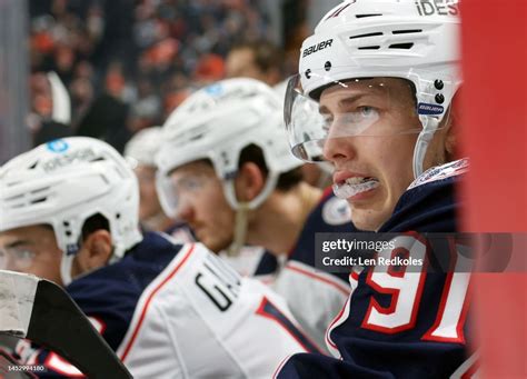Kent Johnson of the Columbus Blue Jackets watches the play on the ice ...