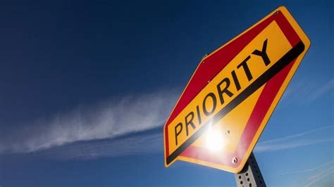 Low angle shot of a priority traffic sign under a clear blue sky ...