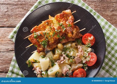 Spanish Food: Kebab Pinchos Morunos and Vegetables Salad Close-up ...
