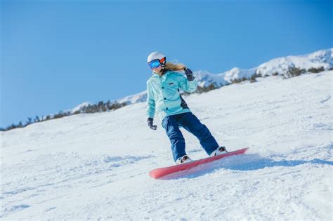 Snowboarder on the slopes on a sunny morning. girl in snowboarder ...