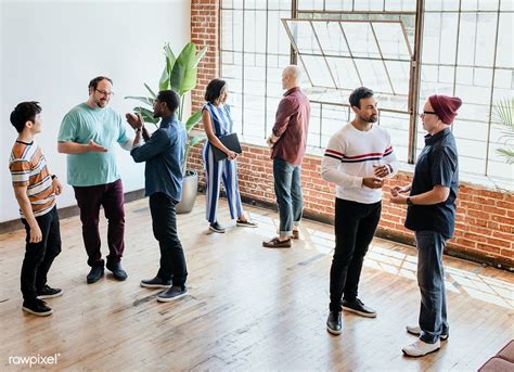 Group of People Standing in a Room Talking 的图像结果