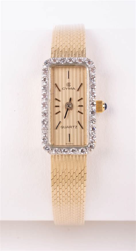 Lot - TWO CYMA 14K YELLOW GOLD WATCHES, ONE WITH DIAMOND BEZEL