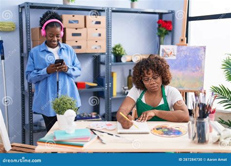 African American Women Artists Listening To Music Drawing on Notebook ...
