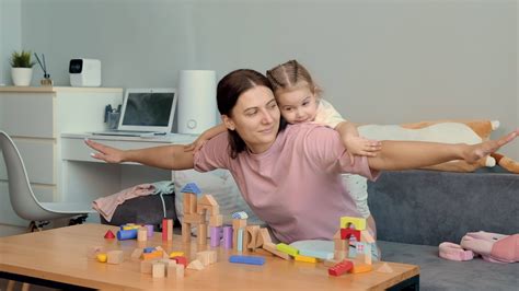 Mom and daughter play at home simulating a flight.Mothers Day,Family ...