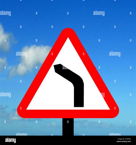 Warning triangle bend to left traffic sign Stock Photo - Alamy