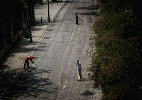 PWD workers cleaning a road on a hot summer day