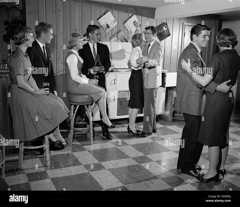 1950s 1960s TEEN COUPLES HAVING PARTY DANCING IN REC ROOM Stock Photo ...