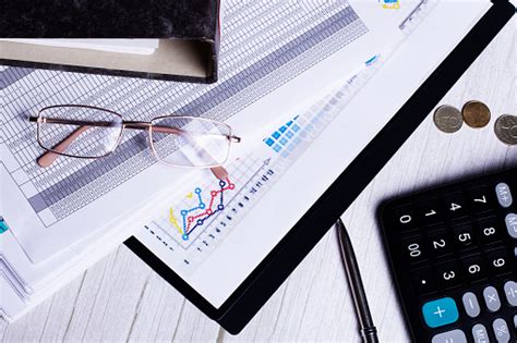 Glasses Calculator Coins Charts And Documents On The Desktop Closeup ...