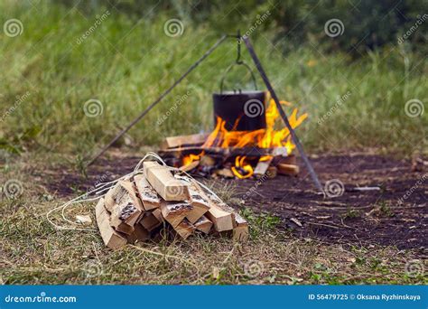 Bundle of Firewood on a Background of the Fire with a Pot Stock Image ...