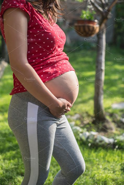 Pregnant woman shows his belly. In t | High-Quality People Images ...