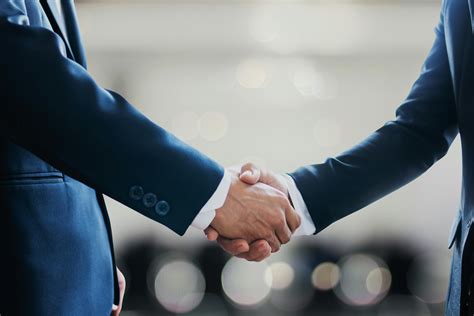Two People Shaking Hands · Free Stock Photo