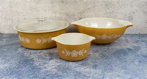 At Auction: Pyrex Butterfly Gold Casserole and Bowls