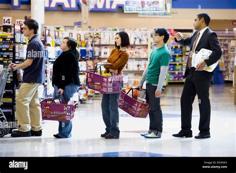People stand in lines at an Upper East Side grocery store in New York.