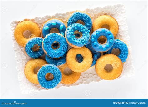 A Platter Topped with a Pile of Plain and Blue Chocolate Dipped Donuts ...