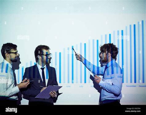 Confident businessman presenting his colleagues report of progress ...