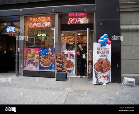 Signs for Kentucky Fried Chicken and Dunkin Donuts fast food franchises ...