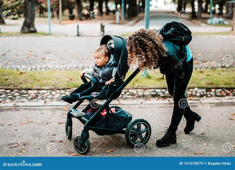 Happy Mom Pushing Stroller and Smiling, Laughing. Young Mother Taking ...